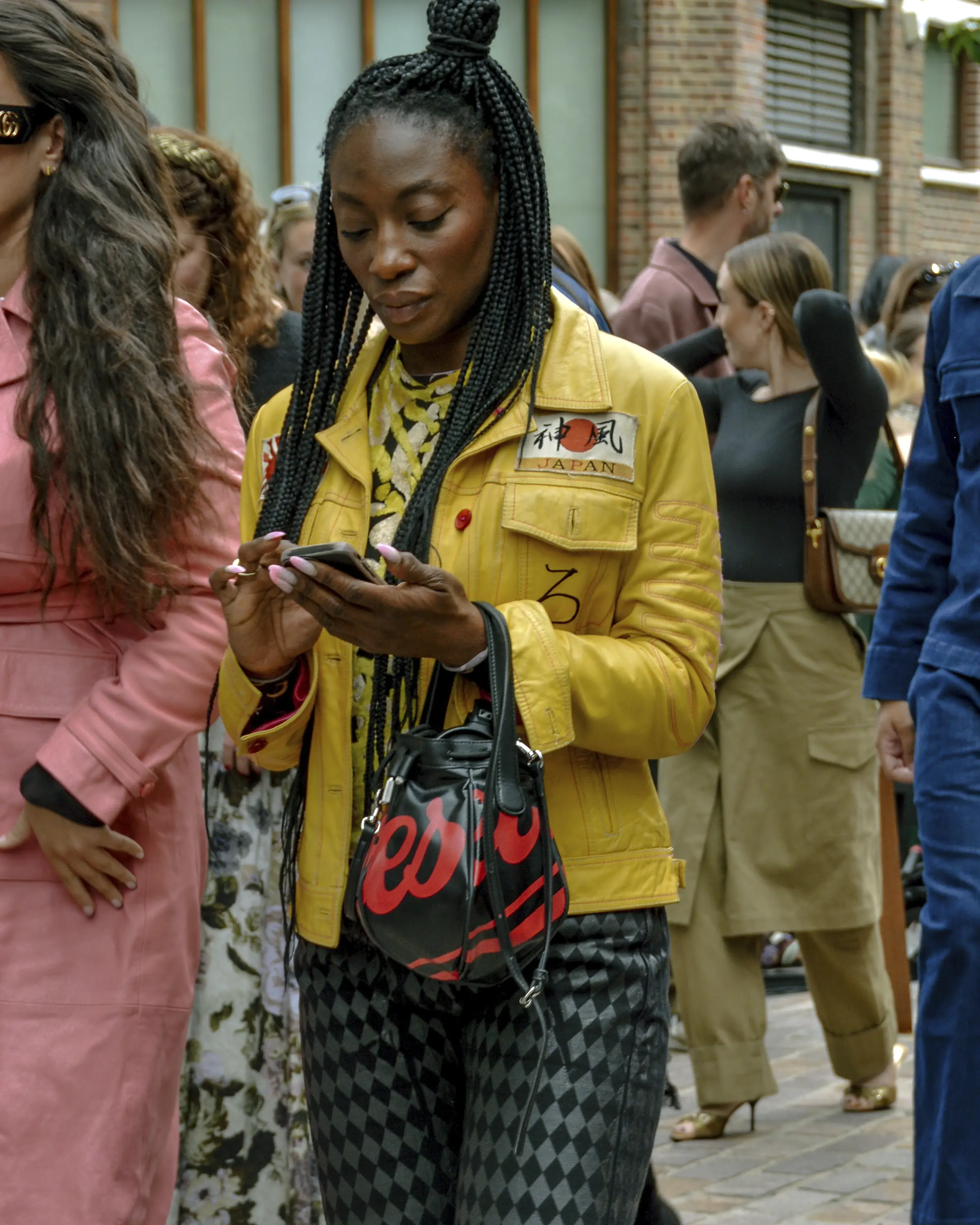 Street style of a woman with a yellow stylish leather jacket