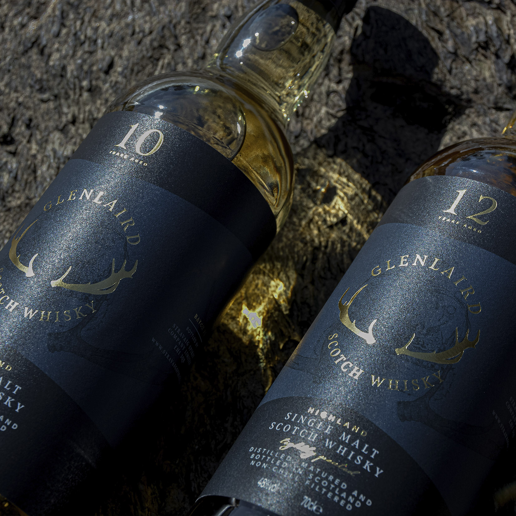 10 and 12 close up Close-up of Glenlaird's whisky label showcasing a hand-illustrated crown with intricate details and gold foil printing, highlighting the luxurious and artisanal quality of the packaging design.