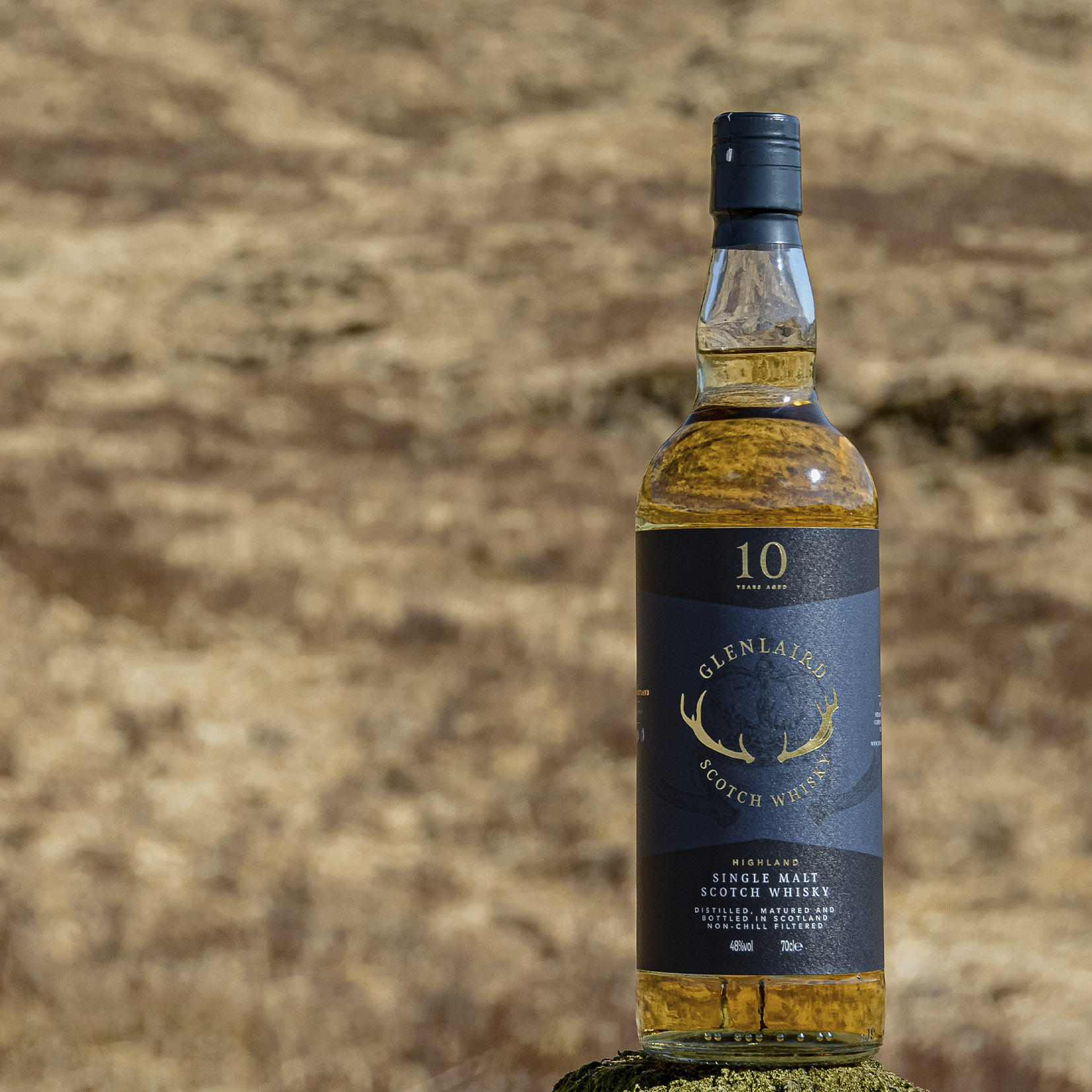 Glenlaird Golden Close-up of Glenlaird's whisky label showcasing a hand-illustrated crown with intricate details and gold foil printing, highlighting the luxurious and artisanal quality of the packaging design.